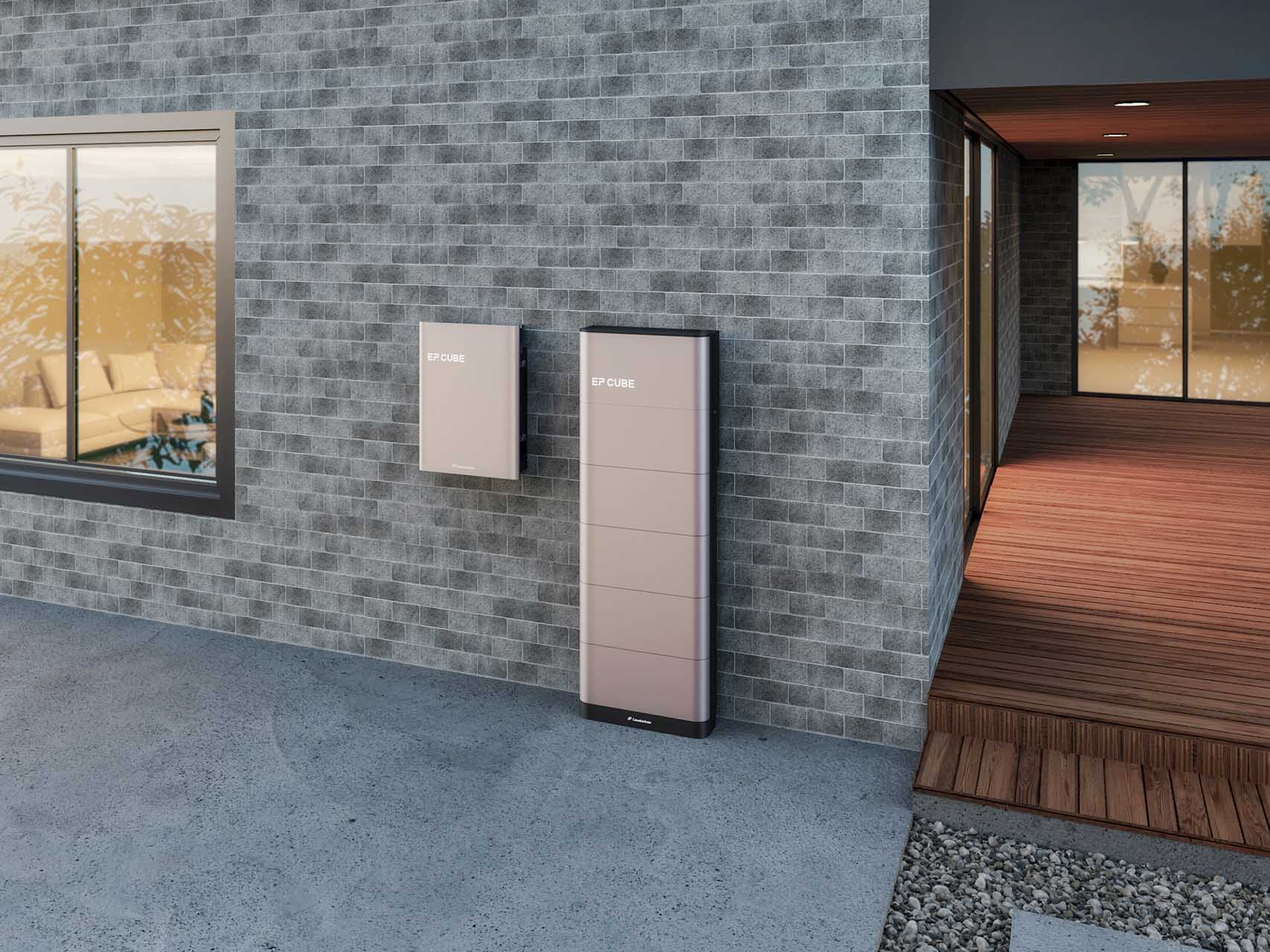 EP Cube battery backup system mounted on an exterior brick wall near a modern home entryway.